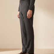Model wearing The Wentworth charcoal wool dress trousers, side profile from the chest down