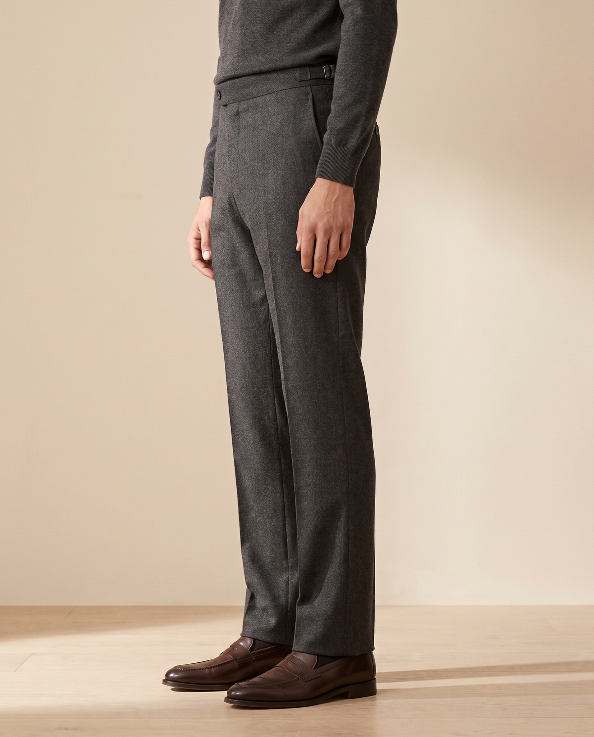Model wearing The Wentworth charcoal wool dress trousers, side profile from the chest down