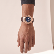 The Ascot leather strap watch worn on the wrist with the hand relaxed at the side