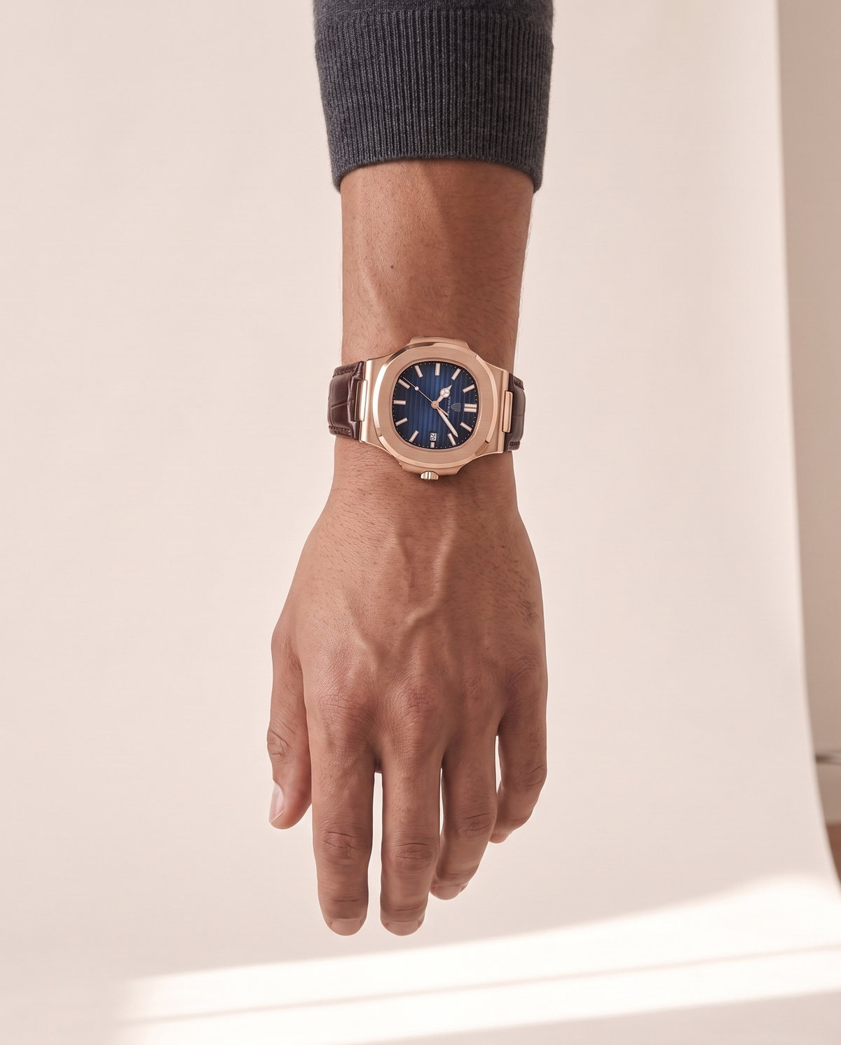 The Ascot leather strap watch worn on the wrist with the hand relaxed at the side