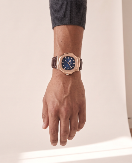 The Ascot leather strap watch worn on the wrist with the hand relaxed at the side