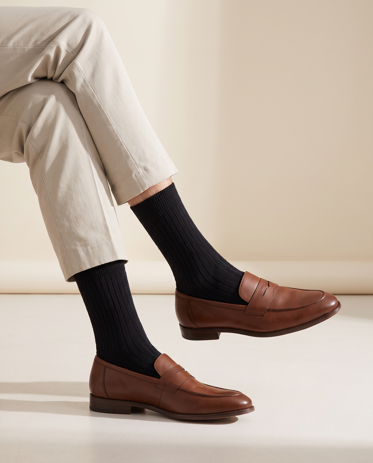 The ribbed socks worn with loafers below cropped stone trousers