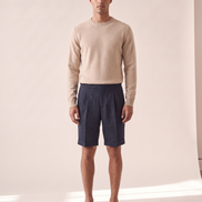 Model wearing The Tenby pleated linen shorts, front view