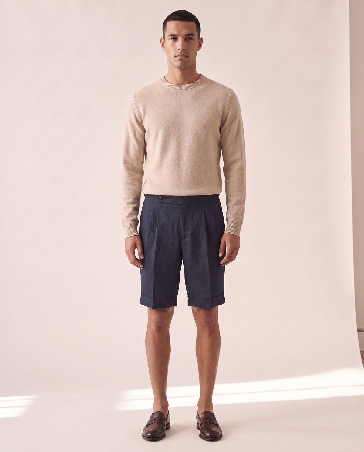 Model wearing The Tenby pleated linen shorts, front view