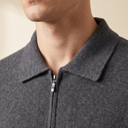 Close-up of the folded pointed collar and zip pull on the grey cashmere cardigan