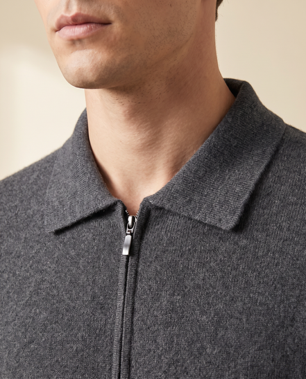 Close-up of the folded pointed collar and zip pull on the grey cashmere cardigan