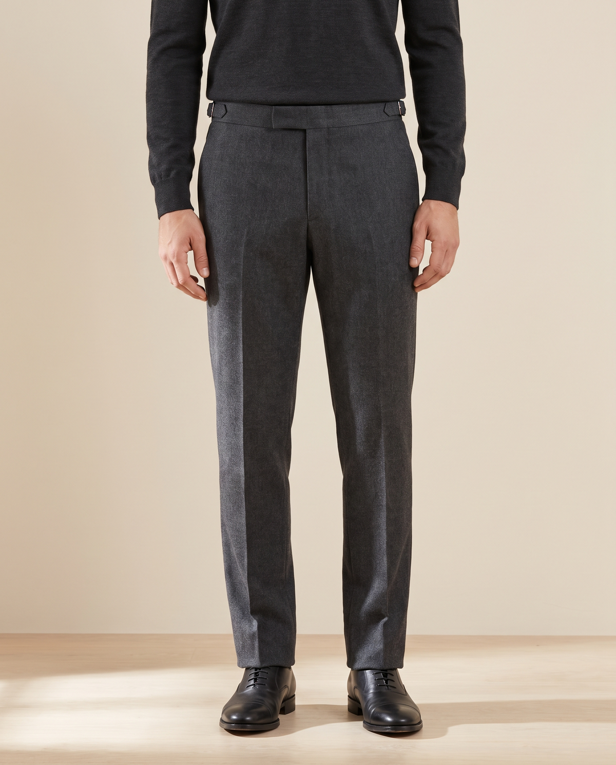 Model wearing The Wentworth charcoal wool dress trousers, front view from the chest down