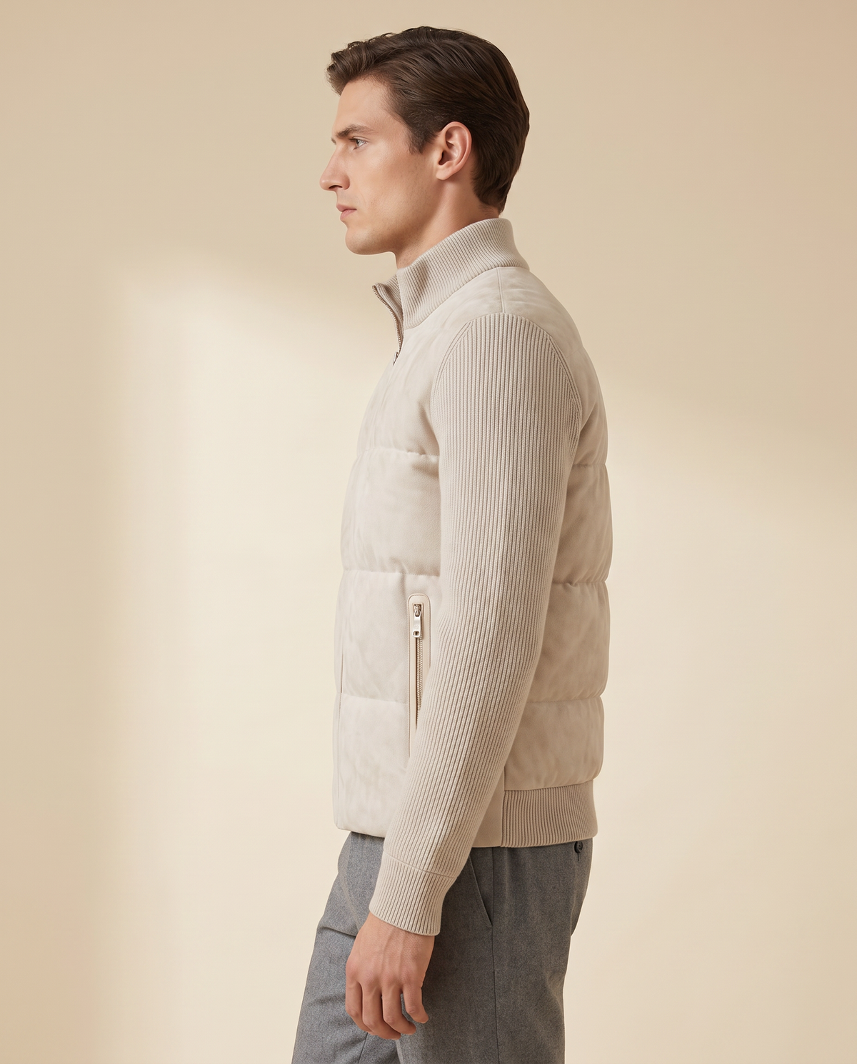 Model wearing the cream hybrid bomber, side profile showing knitted sleeve