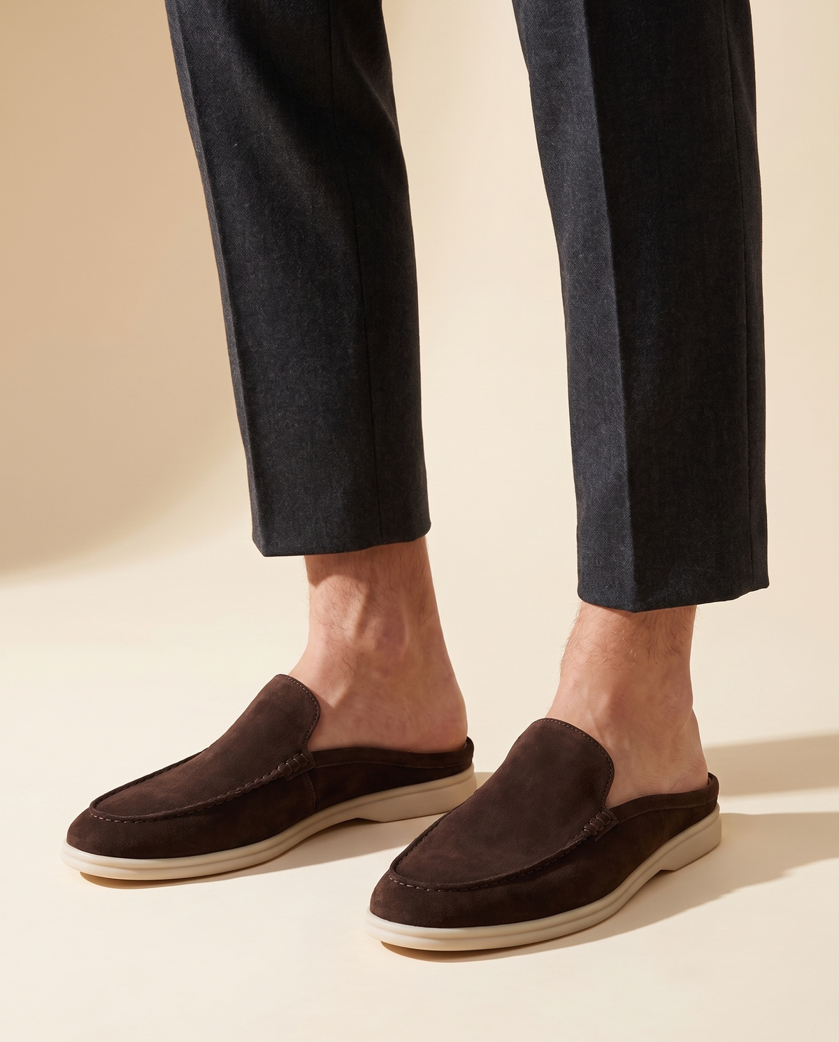 Model wearing the dark coffee brown suede mules with cropped trousers