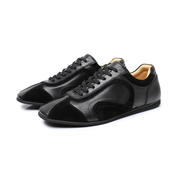 The Cadogan retro leather trainer in black, three-quarter front view of the pair