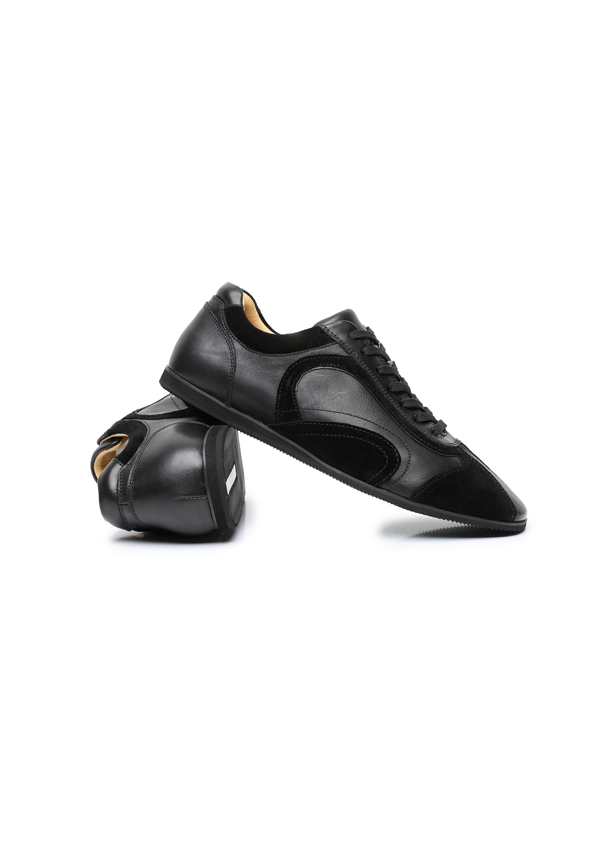 The Cadogan trainer in black, one shoe turned to show the lining