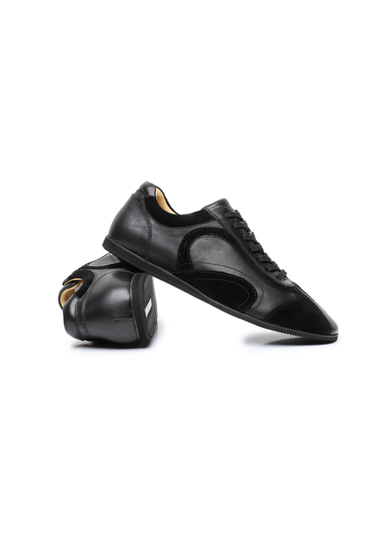 The Cadogan trainer in black, one shoe turned to show the lining