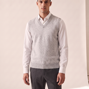 Model wearing The Rutland merino V-neck vest over a white shirt, front view