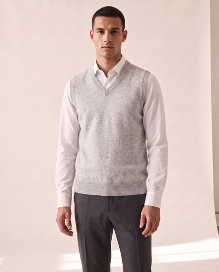 Model wearing The Rutland merino V-neck vest over a white shirt, front view