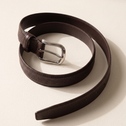 The Chester leather belt laid in an open curve