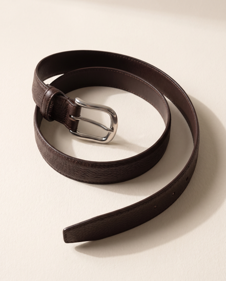 The Chester leather belt laid in an open curve