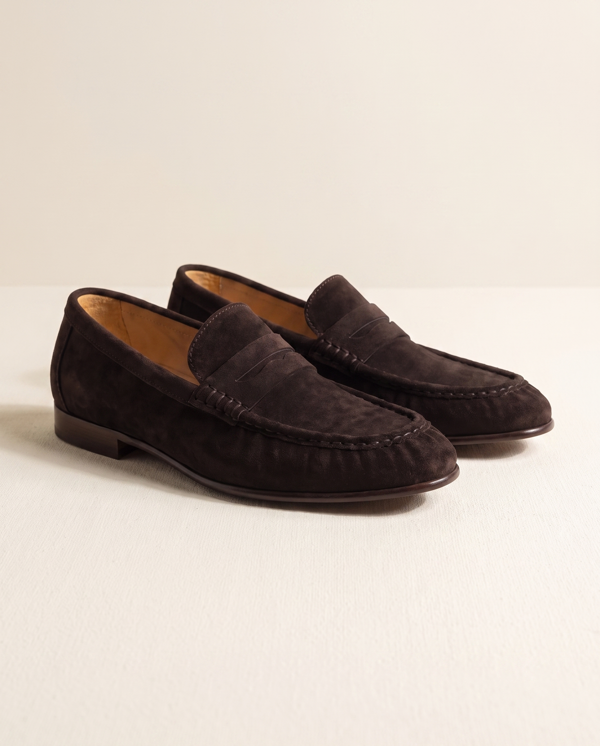 The Hampton coffee suede penny loafers, three-quarter view