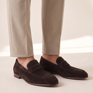 The Hampton penny loafers worn without socks with stone trousers