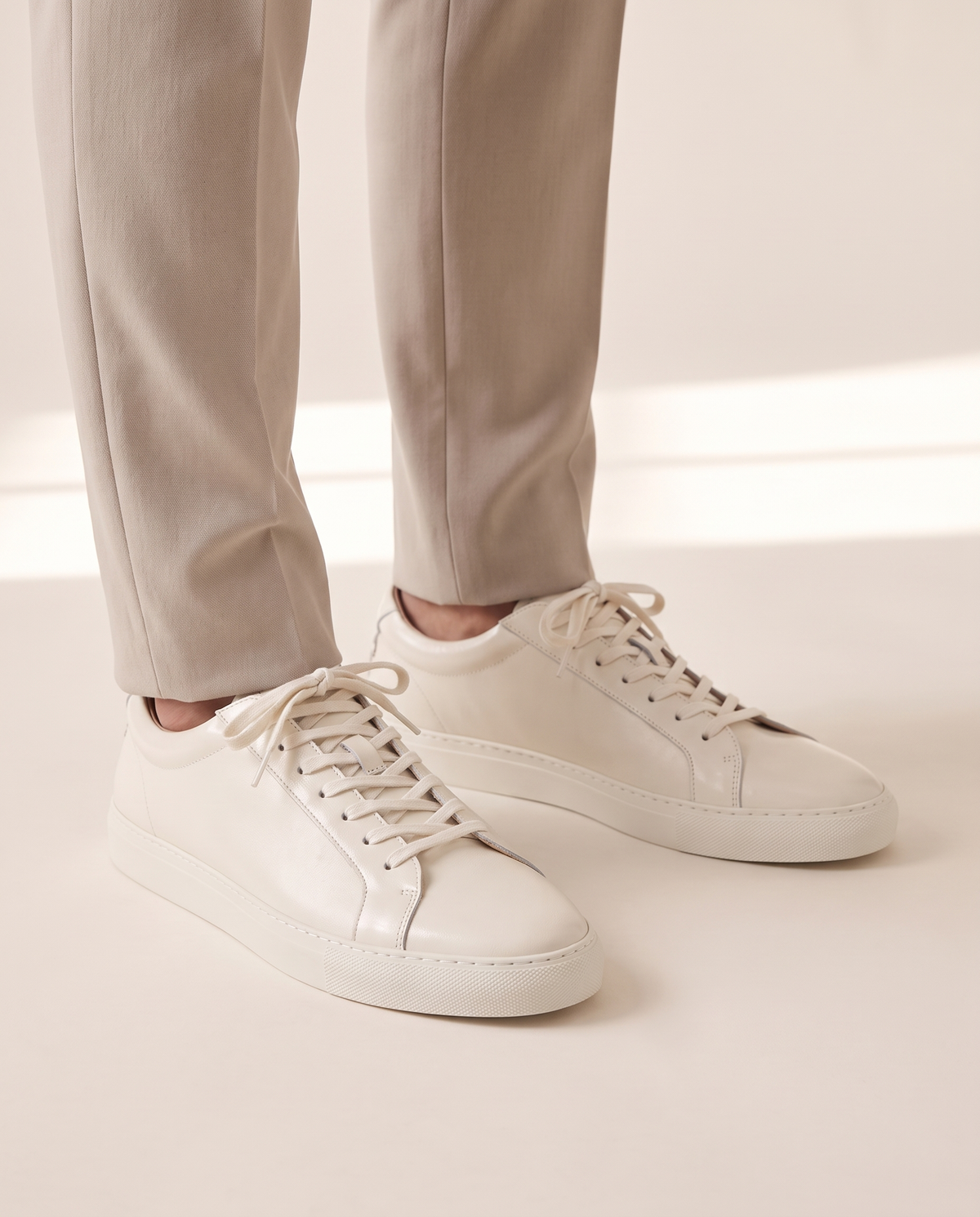 The Stanmore leather sneakers worn with stone trousers