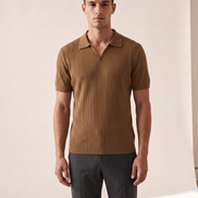 Model wearing The Henley open-collar knit polo, front view
