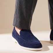 Close-up of The Bayswater worn, low three-quarter on the suede vamp and white sole at the trouser break