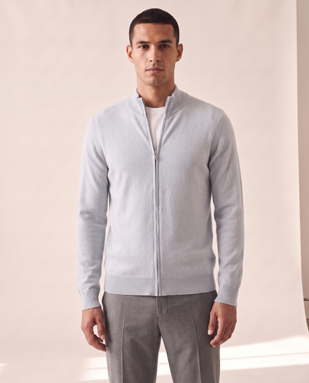 Model wearing the light blue merino zip cardigan, front view