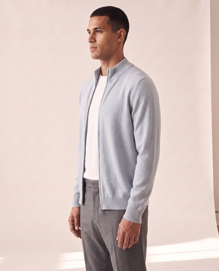 Model wearing the light blue merino zip cardigan, side profile