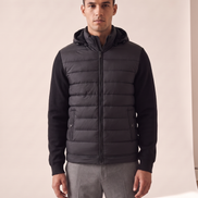 Model wearing The Norfolk Hybrid Down Jacket, front view, hood up around the neck