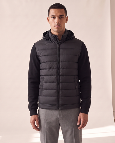 Model wearing The Norfolk Hybrid Down Jacket, front view, hood up around the neck