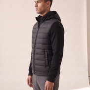 Model wearing The Norfolk Hybrid Down Jacket, side profile, hood up around the neck