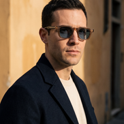 The Kingsley Round Sunglasses worn on a sunlit street