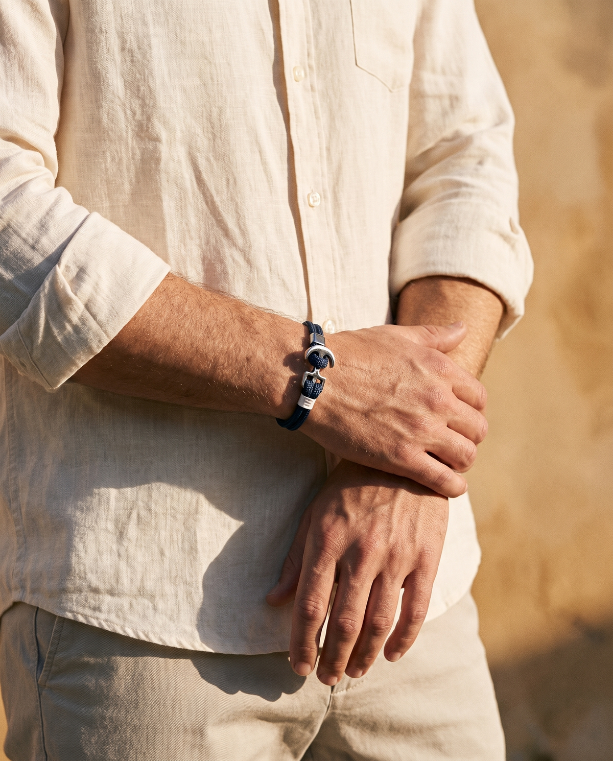 The Hythe Anchor Cord Bracelet worn with rolled linen