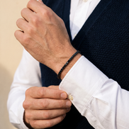 The Onslow Black Stone Tennis Bracelet worn with a knitted waistcoat