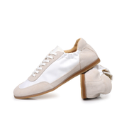The Petersham trainer in ivory, one shoe turned to show the lining