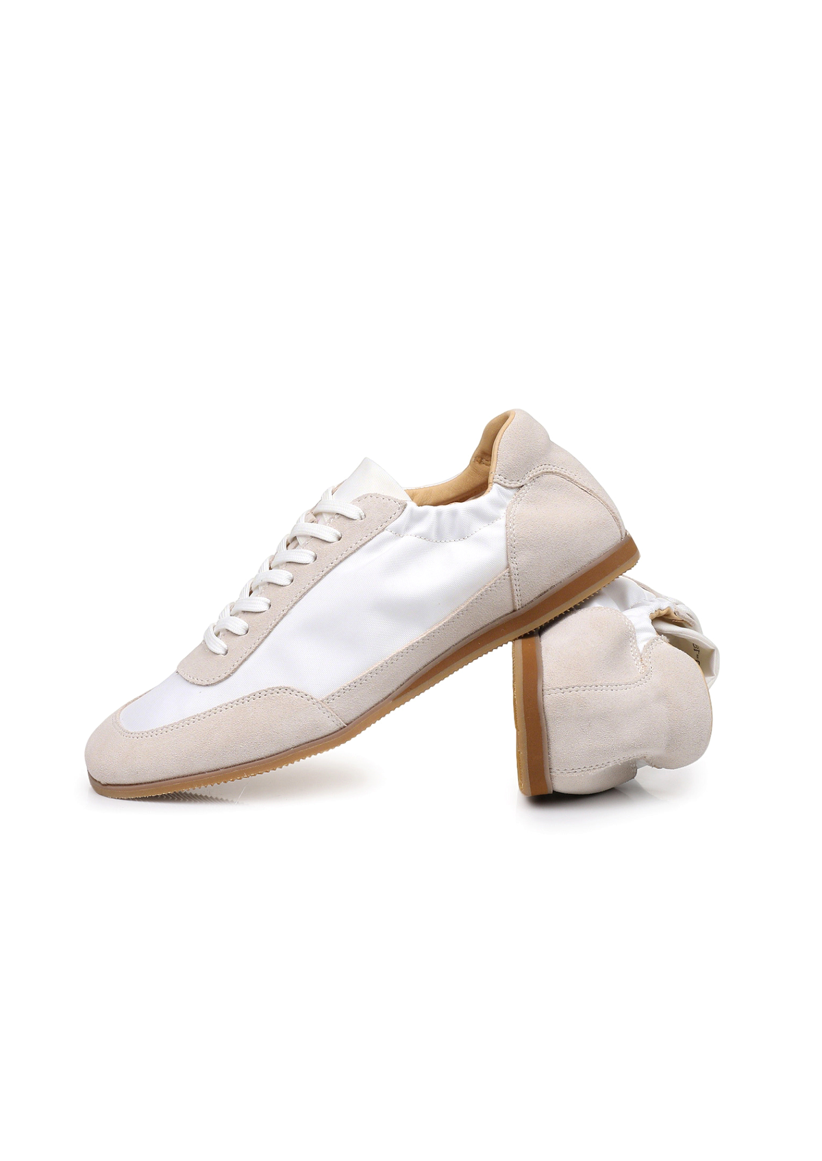 The Petersham trainer in ivory, one shoe turned to show the lining